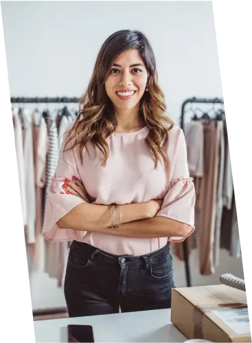 A young woman standing in a clothing shop, thoughtfully exploring fashion trends and career opportunities in the retail industry.
